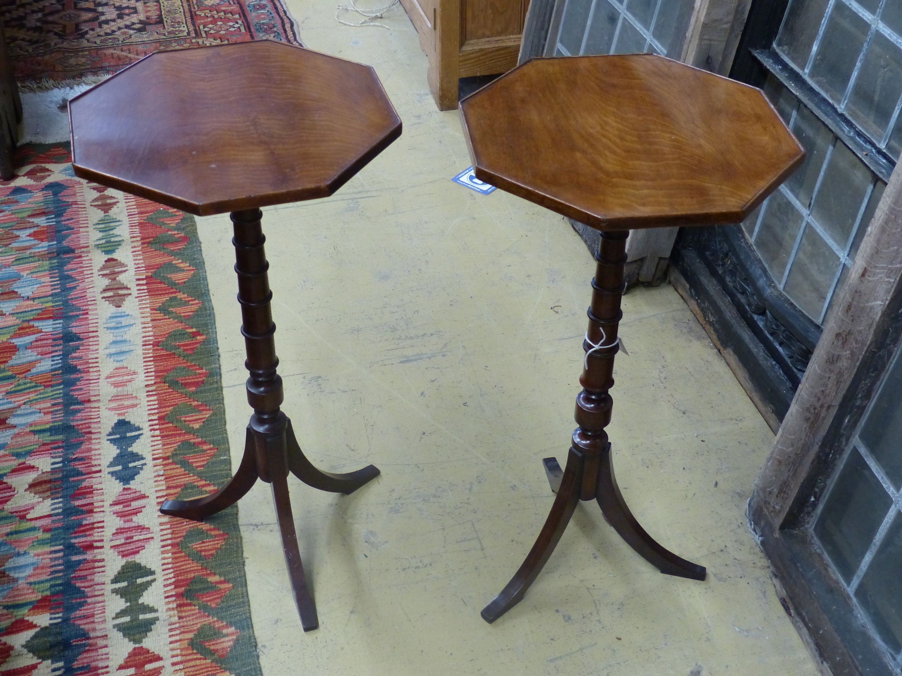 A pair of Regency style mahogany octagonal wine tables